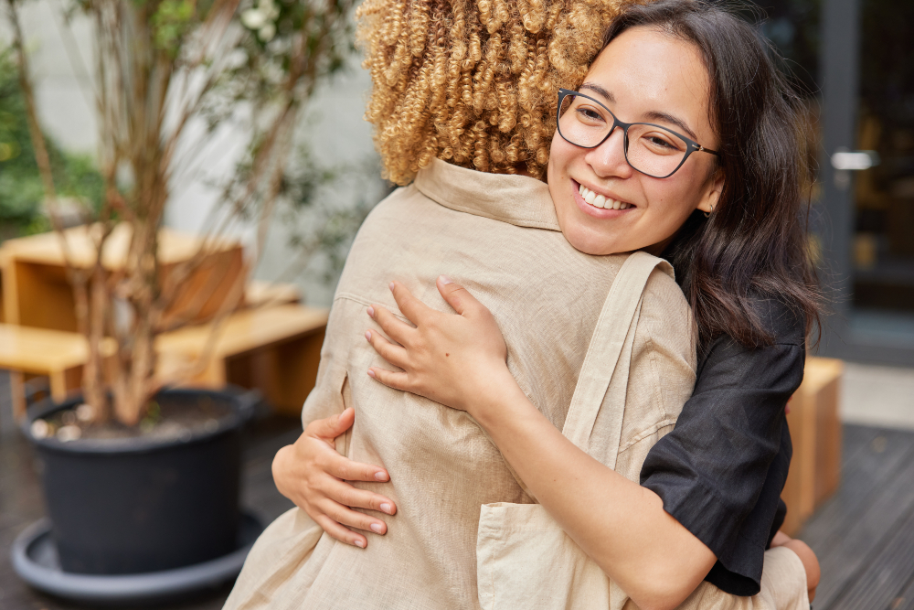 Two women hugging in treatment for suicidal ideation in fresno and visalia.